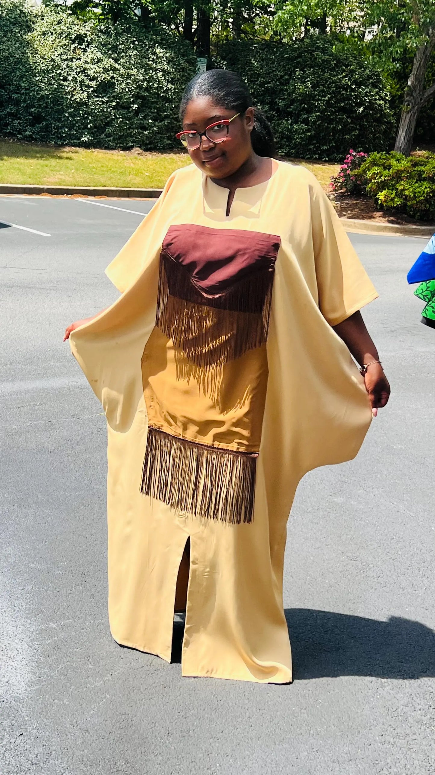 Woman wearing a plain crepe Bubu gown with wide sleeves and a relaxed fit, standing outdoors.