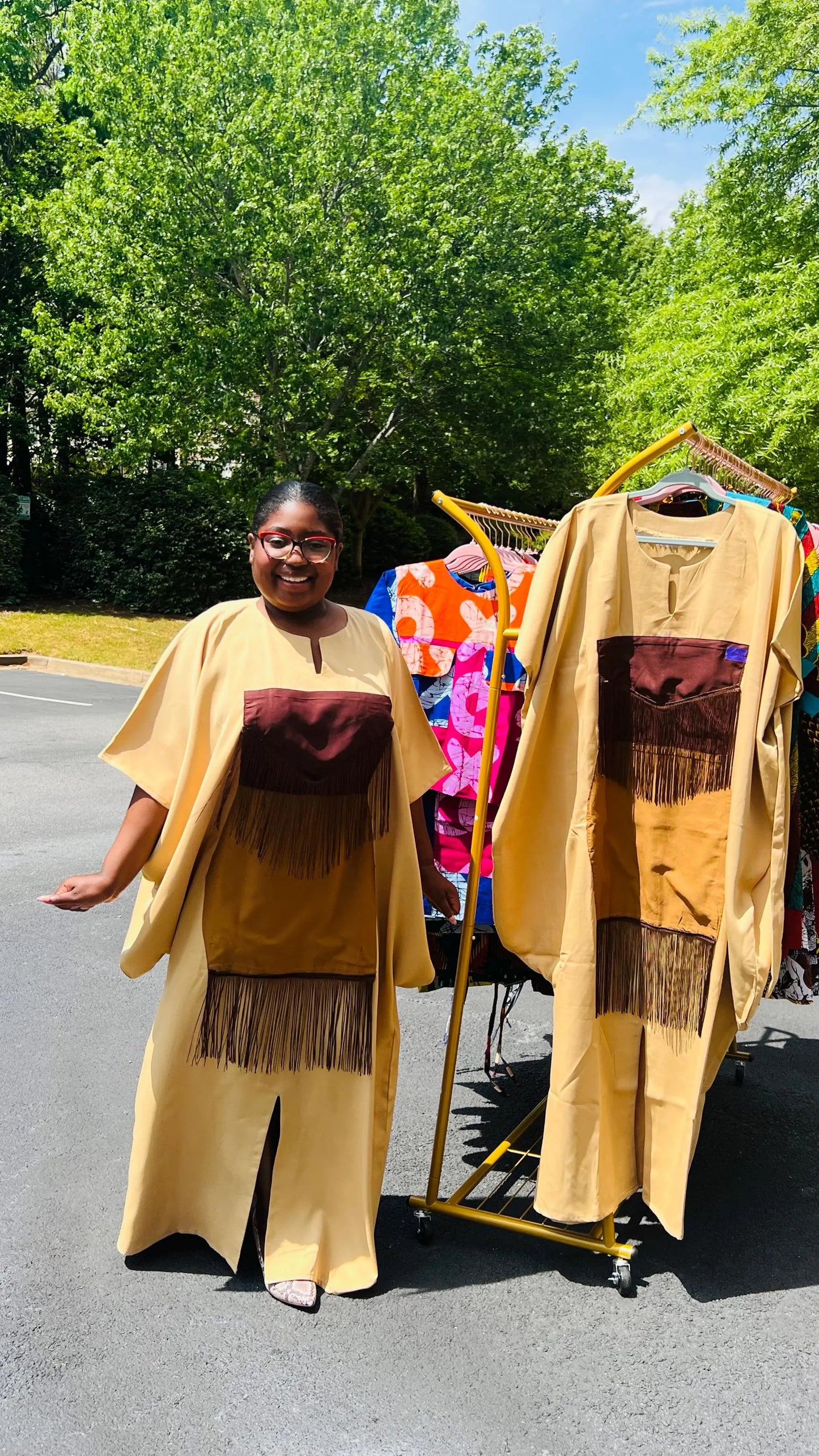 Woman wearing a plain crepe Bubu gown with wide sleeves and a relaxed fit, standing outdoors.