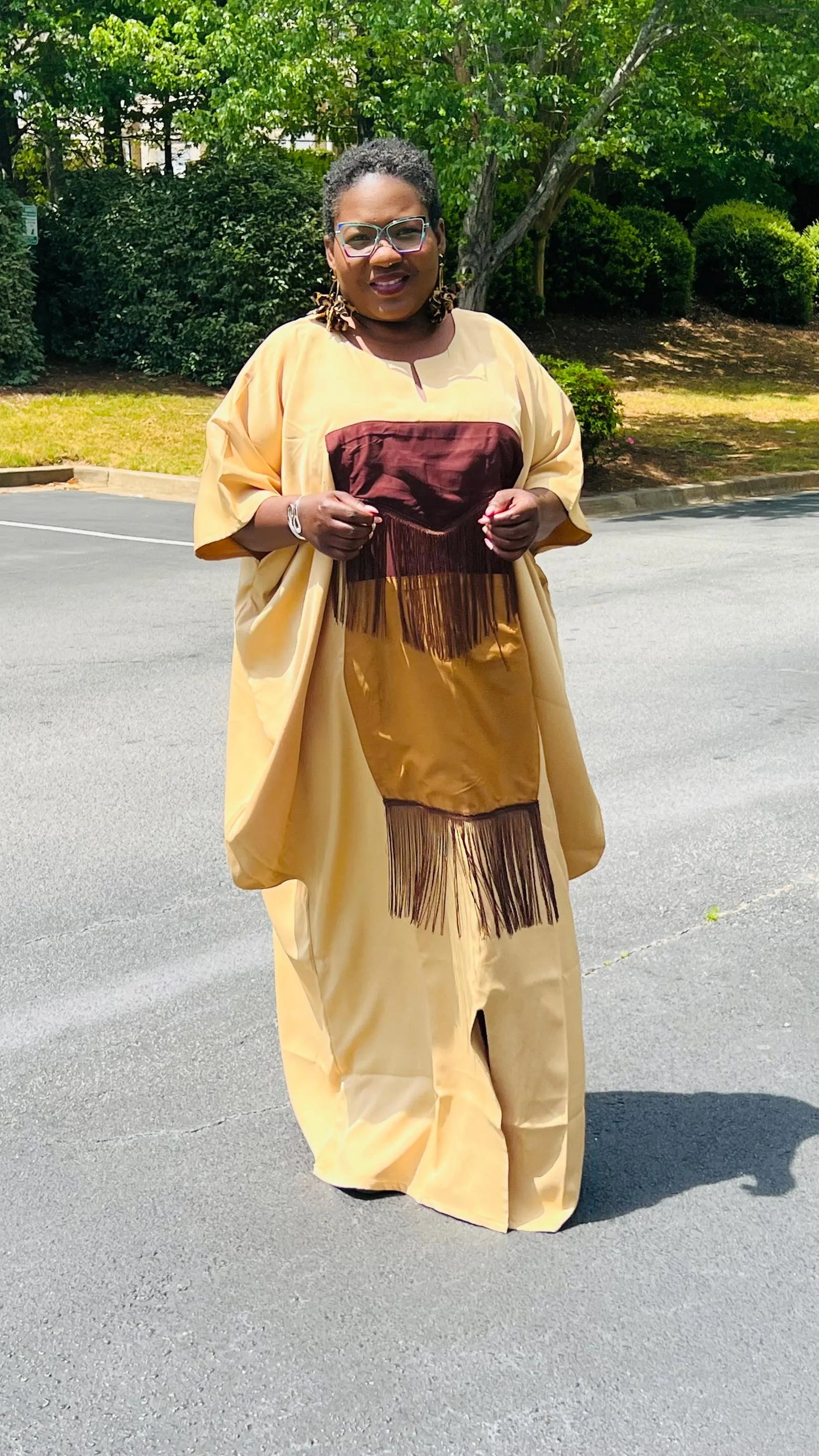 Woman wearing a plain crepe Bubu gown with wide sleeves and a relaxed fit, standing outdoors.