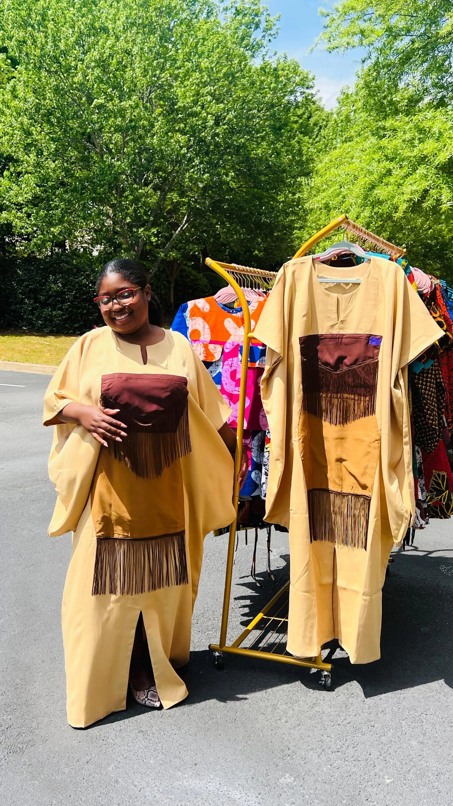 Woman wearing a plain crepe Bubu gown with wide sleeves and a relaxed fit, standing outdoors.