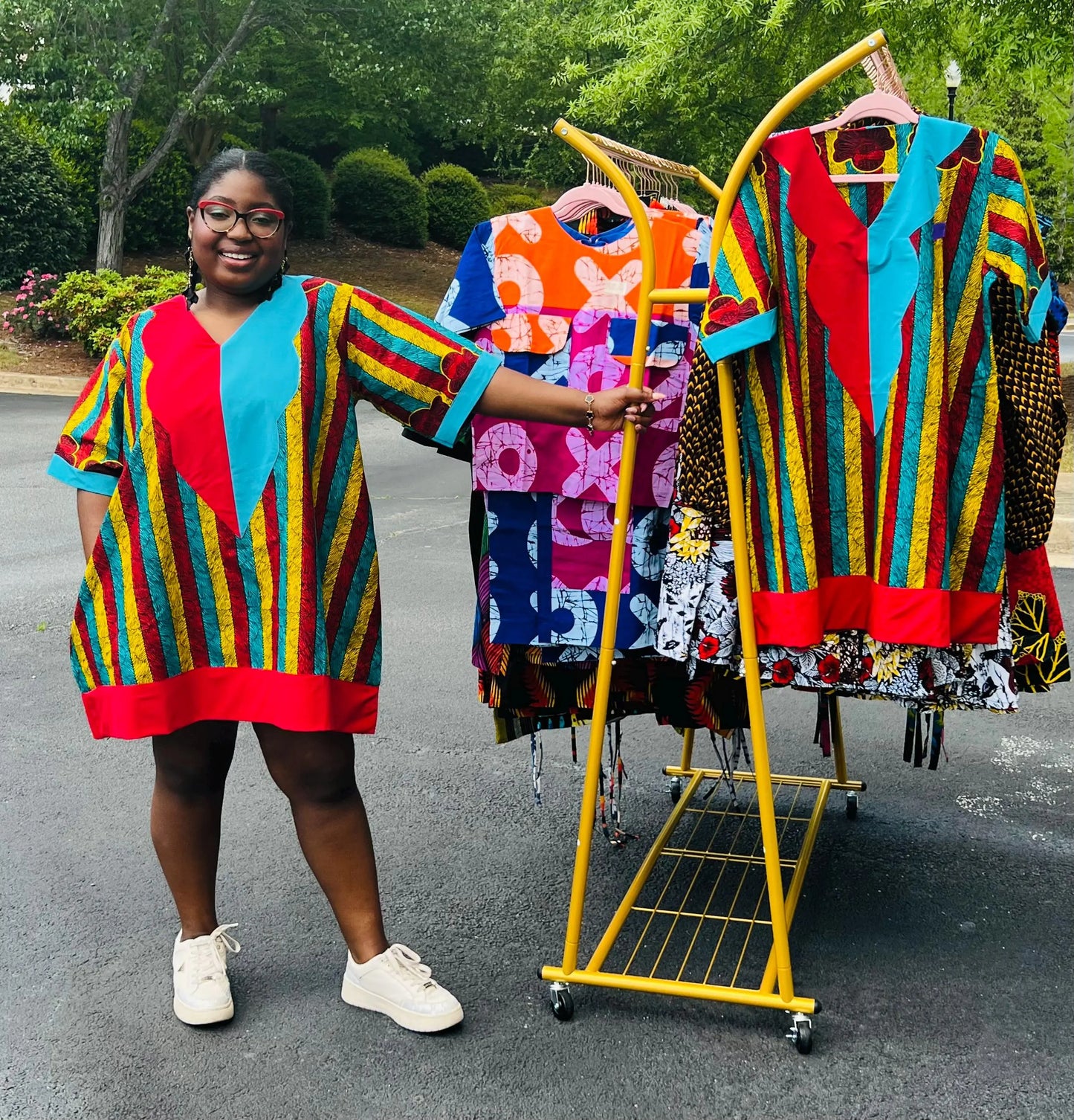 Woman wearing a vibrant African Ankara print mini dress with short sleeves and a flattering A-line silhouette, standing outdoors.