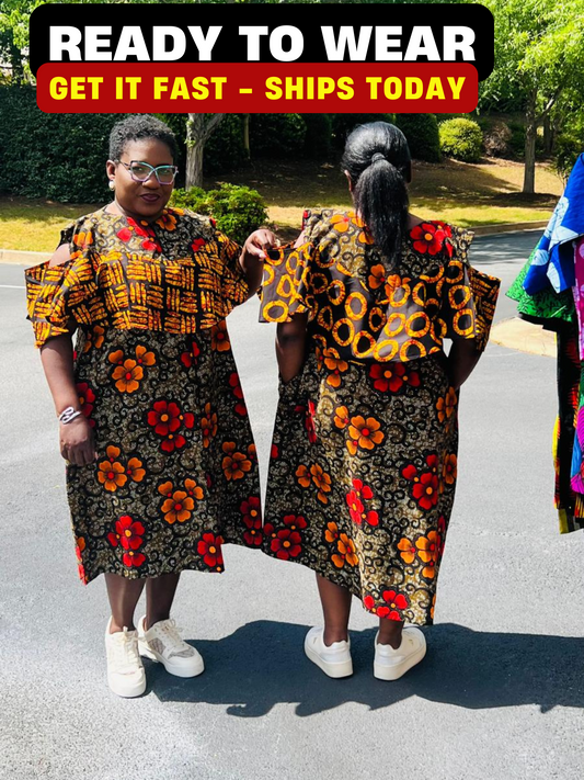 Woman wearing a reversible Ankara dress with open shoulders, ruffled A-line skirt, and front zipper, standing outdoors.