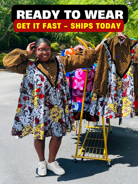 Woman wearing a vibrant Ankara A-line dress with puff sleeves, velvet button-up front, and knee-length hem, standing outdoors.