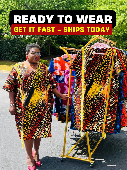 Model wearing a vibrant Ankara A-line dress with glitter trim and short sleeves, standing outdoors.