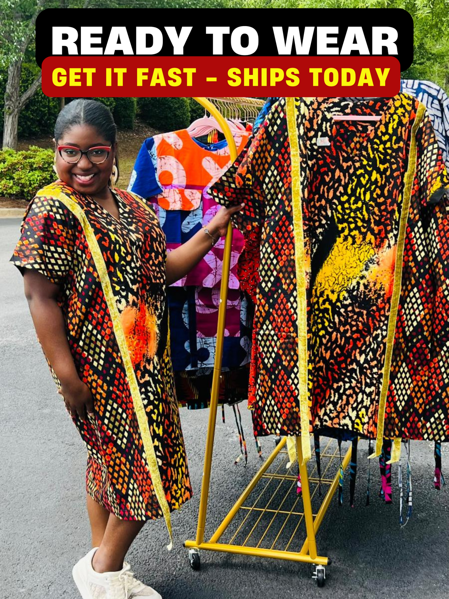 Model wearing a vibrant Ankara A-line dress with glitter trim and short sleeves, standing outdoors.