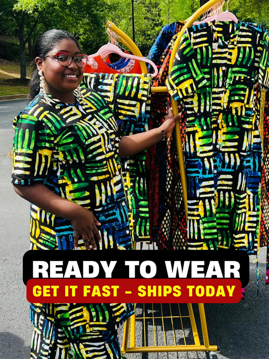 Woman wearing a two-piece Ankara outfit featuring a button-up top and matching baggy pants with an elastic waistband, standing outdoors.