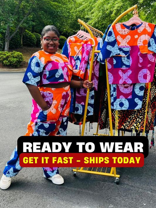 Woman wearing a vibrant two-piece Ankara ensemble featuring a sleeveless crop top and high-waisted cargo pants with multiple pockets, standing outdoors.