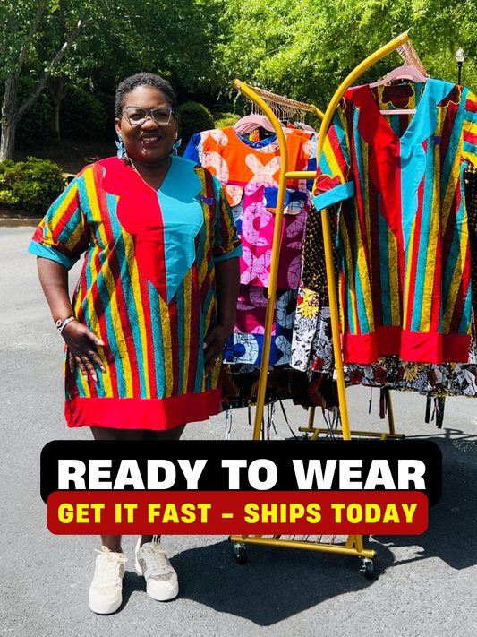 Woman wearing a vibrant African Ankara print mini dress with short sleeves and a flattering A-line silhouette, standing outdoors.