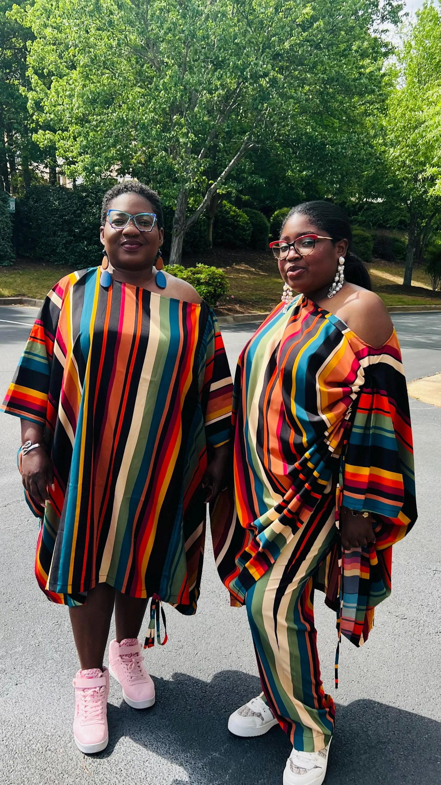 Woman wearing a two-piece African print set featuring an off-shoulder drawstring Bubu top and matching wide-leg pants, standing outdoors.
