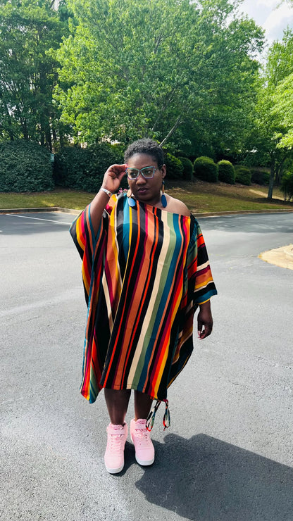 Woman wearing a two-piece African print set featuring an off-shoulder drawstring Bubu top and matching wide-leg pants, standing outdoors.