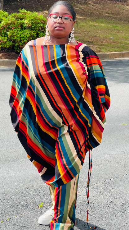 Woman wearing a two-piece African print set featuring an off-shoulder drawstring Bubu top and matching wide-leg pants, standing outdoors.
