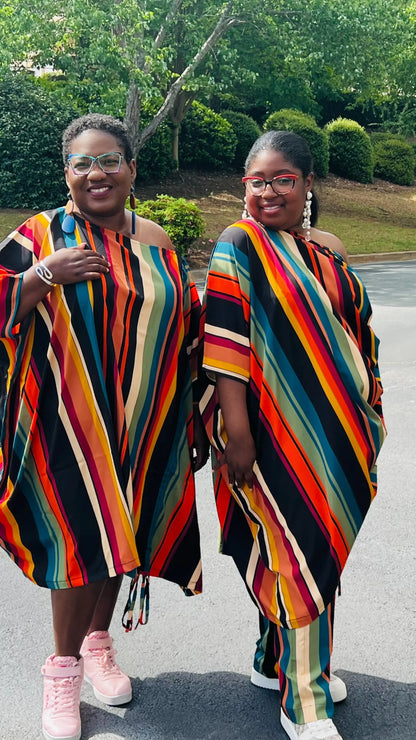 Woman wearing a two-piece African print set featuring an off-shoulder drawstring Bubu top and matching wide-leg pants, standing outdoors.