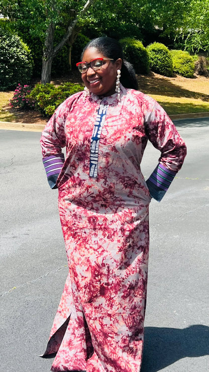 Woman wearing a boho-style maxi dress featuring vibrant Kampala Adire print and Aso Oke accents, with a relaxed fit and wide sleeves.