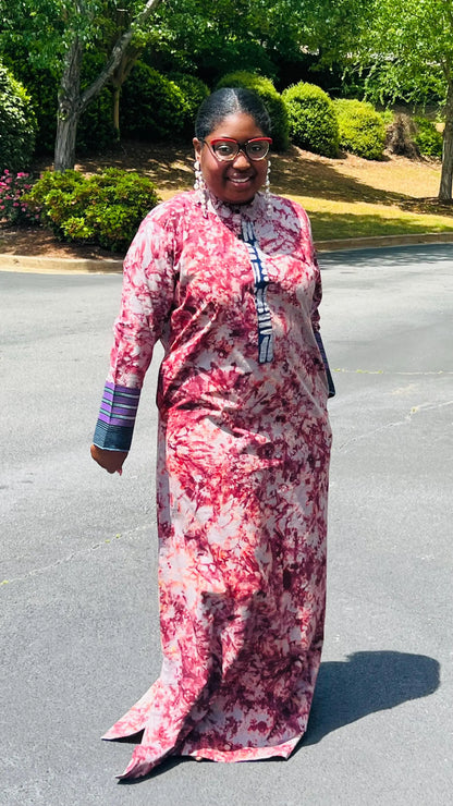 Woman wearing a boho-style maxi dress featuring vibrant Kampala Adire print and Aso Oke accents, with a relaxed fit and wide sleeves.