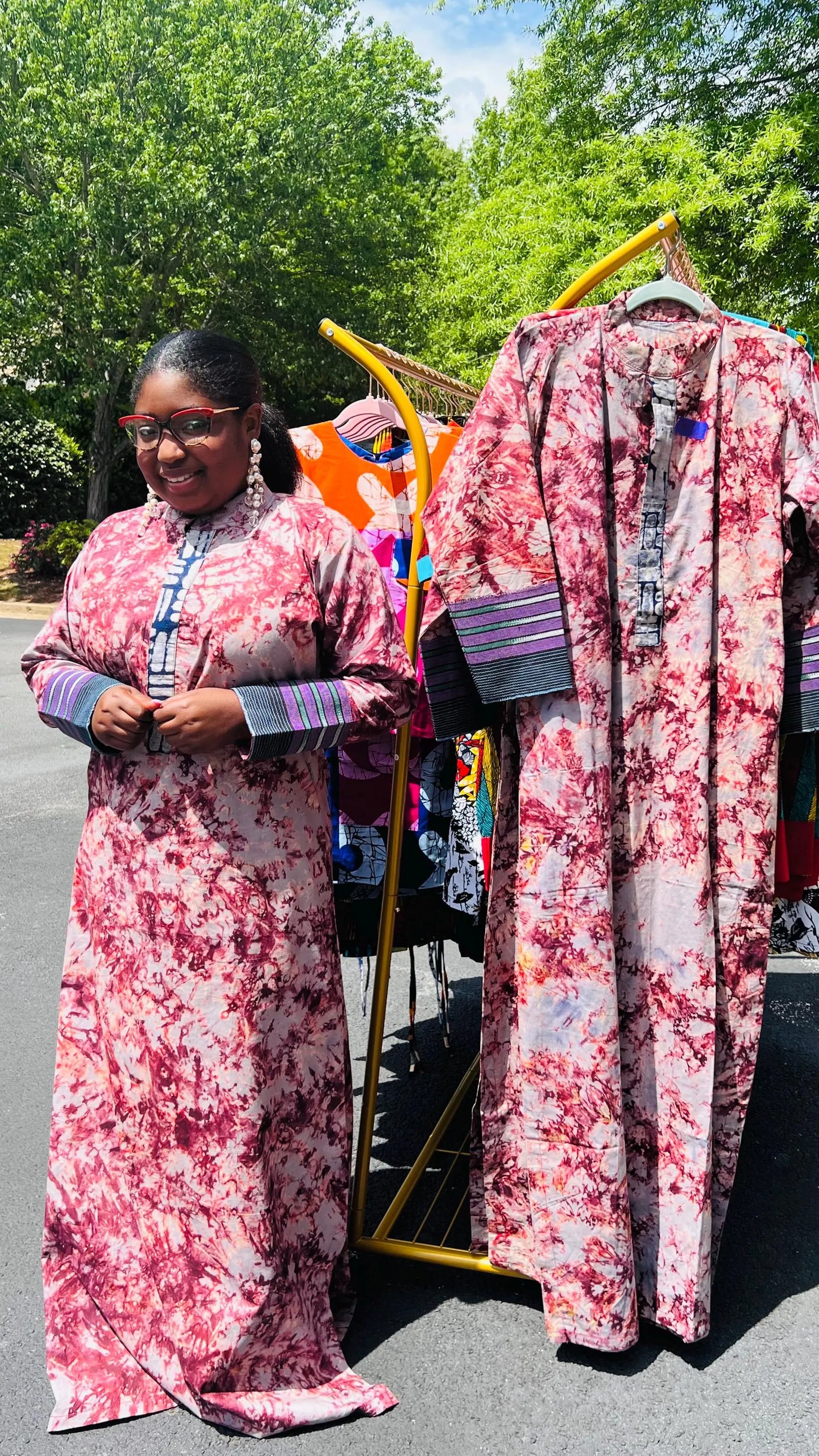 Woman wearing a boho-style maxi dress featuring vibrant Kampala Adire print and Aso Oke accents, with a relaxed fit and wide sleeves.