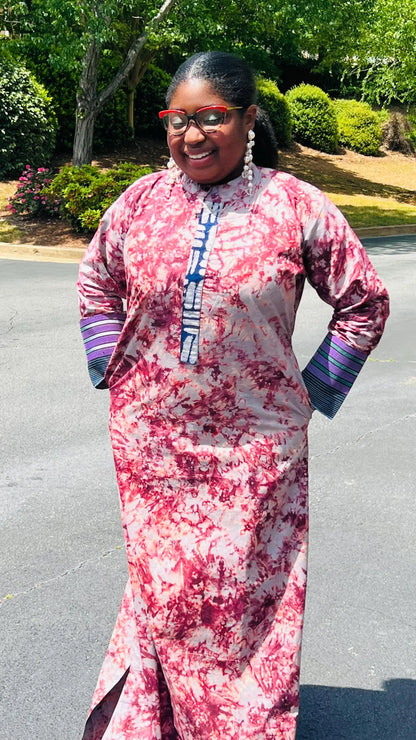 Woman wearing a boho-style maxi dress featuring vibrant Kampala Adire print and Aso Oke accents, with a relaxed fit and wide sleeves.