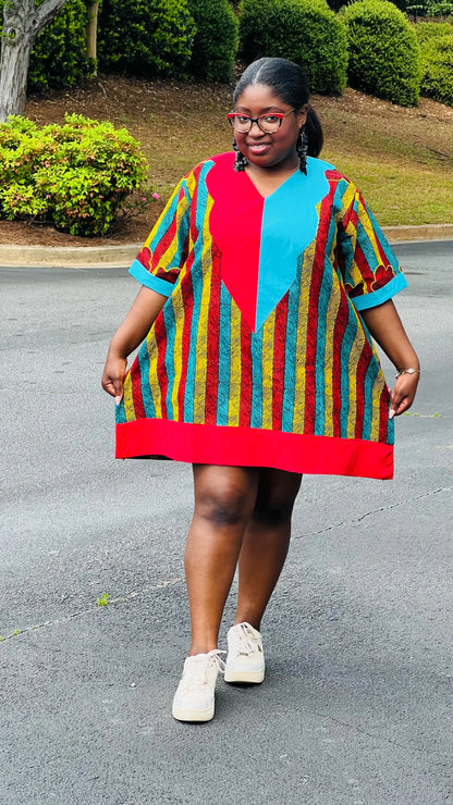 Woman wearing a vibrant African Ankara print mini dress with short sleeves and a flattering A-line silhouette, standing outdoors.