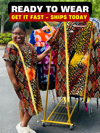 Model wearing a vibrant Ankara A-line dress with glitter trim and short sleeves, standing outdoors.